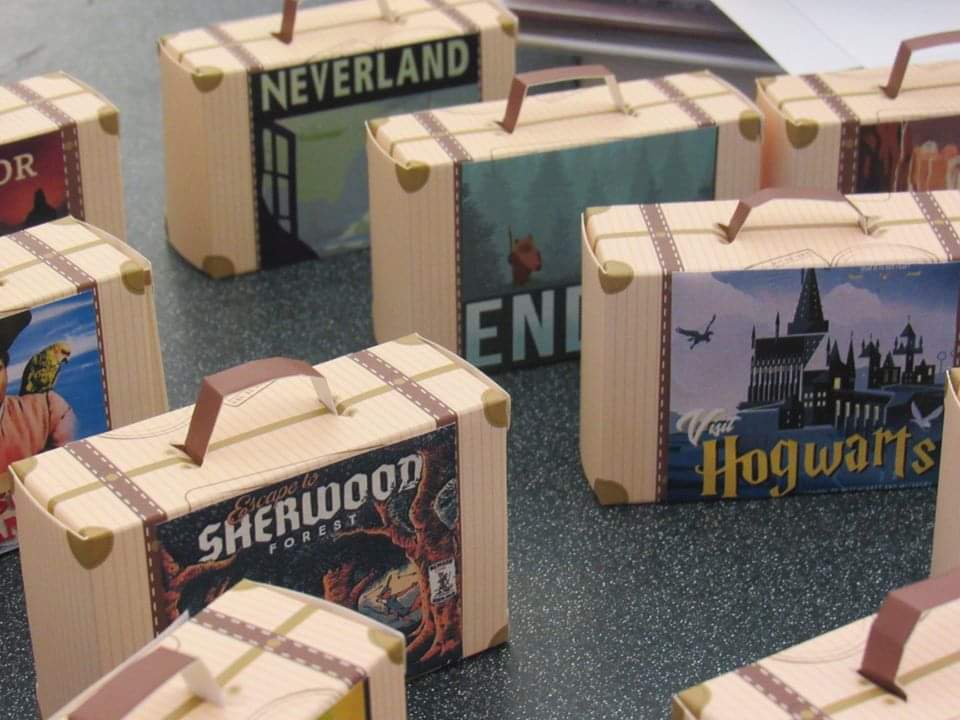 suitcase ornaments with fictional travel destination posters