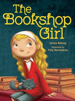 The cover of the book, "The Bookshop Girl" shows a blonde girl sitting on top of a stack of books.