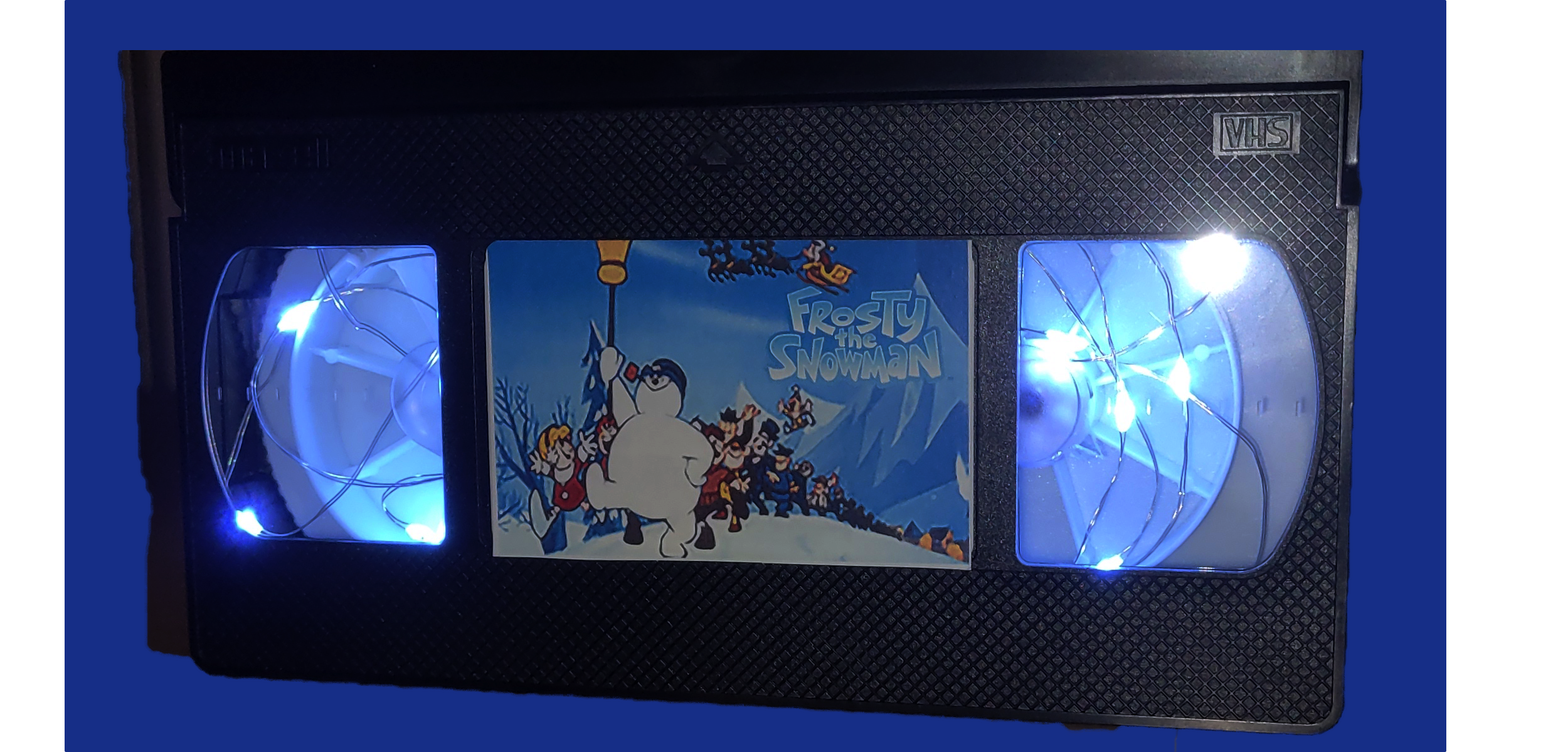 vhs tape with fairy lights and Frosty the Snowman movie sticker