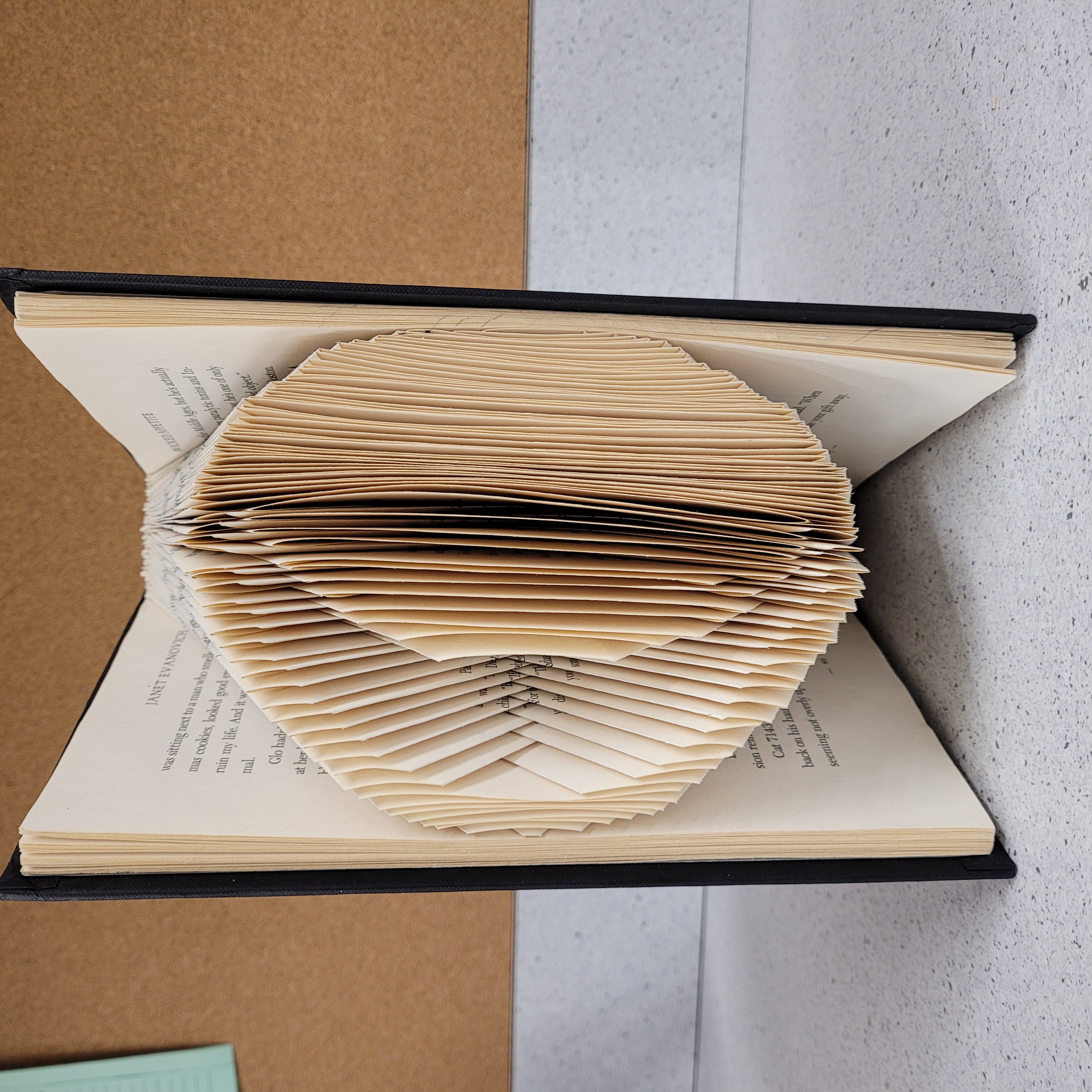 Book folded with a sun and moon design