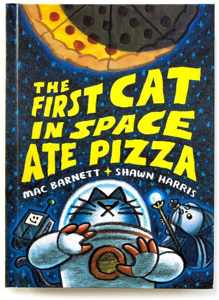 The cover of the book, "The First Cat in Space Ate Pizza" by Mac Barnett, showing a crescent moon made out of pizza and a cat in an astronaut suit surrounded by a robot and a moon queen. 