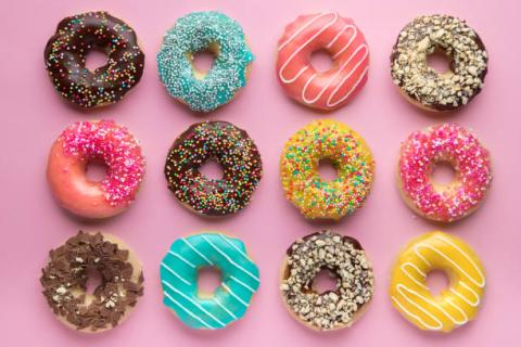 Colorful donuts with a pink background.
