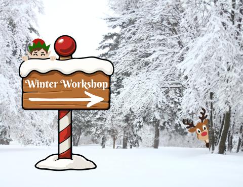 The image depicts an illustrated signpost in the foreground of a realistic-looking snow-covered forest. The sign-post points to the right, with text that reads "Winter Workshop." A North Pole elf peeks over the top of the sign, and in the background, a reindeer peeks out from behind a tree.