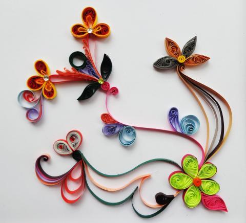Quilled flowers with various different colors (orange, black, green, blue)