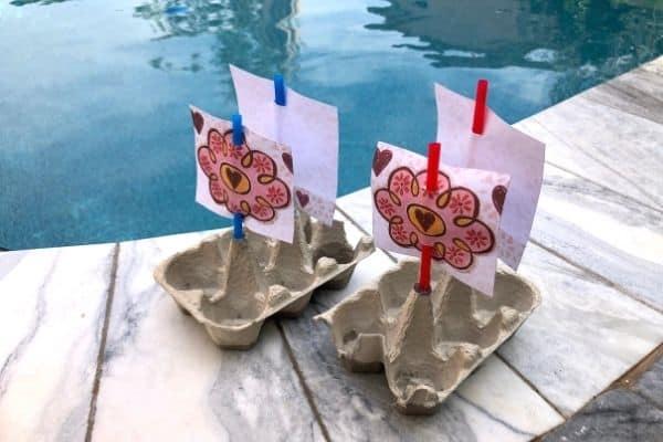 Two Egg Carton Boats by a poolside